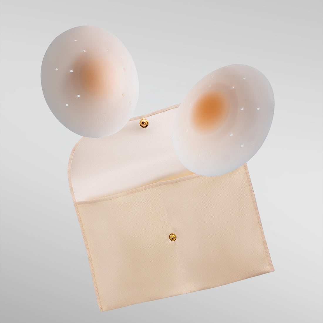 Pair of Essential petals in fair shade with breathe points and adhesive-free center and storage pouch.