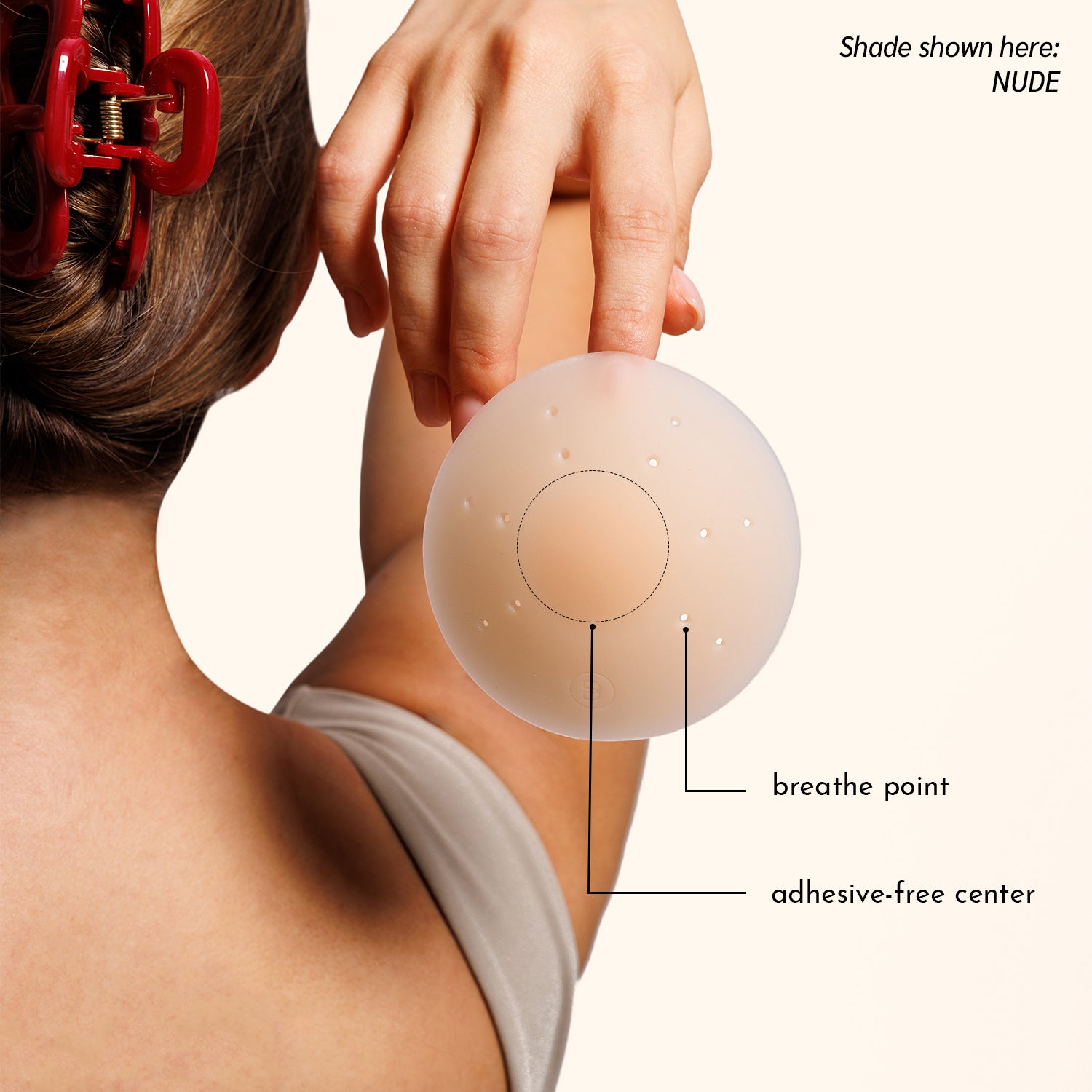 Woman in beige top demonstrating Essential petal's light adhesion method