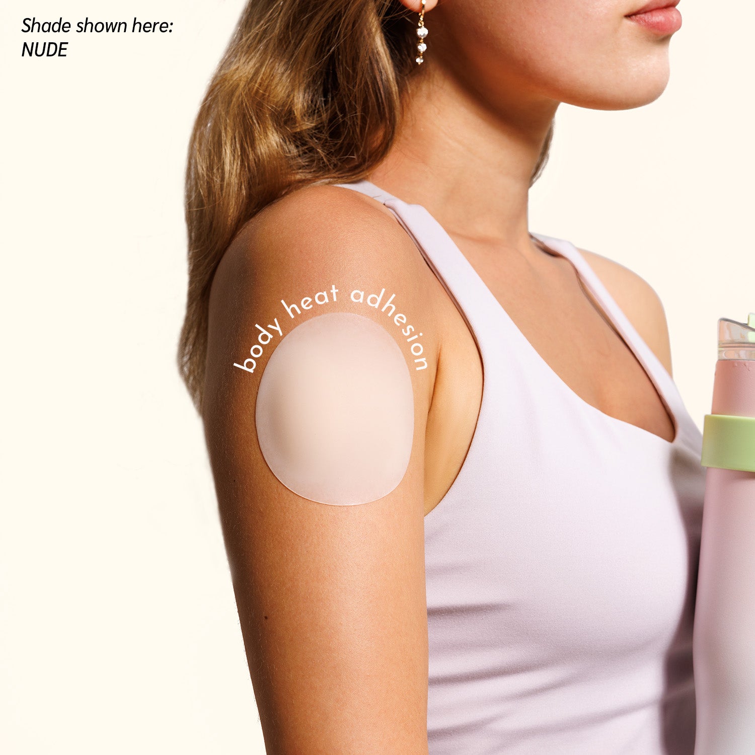 Woman in white tank top demonstrating Naturelle petal body heat adhesion method