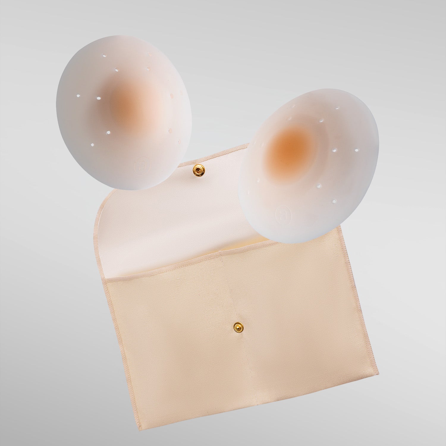 Pair of Essential petals in fair shade with breathe points and adhesive-free center and storage pouch.