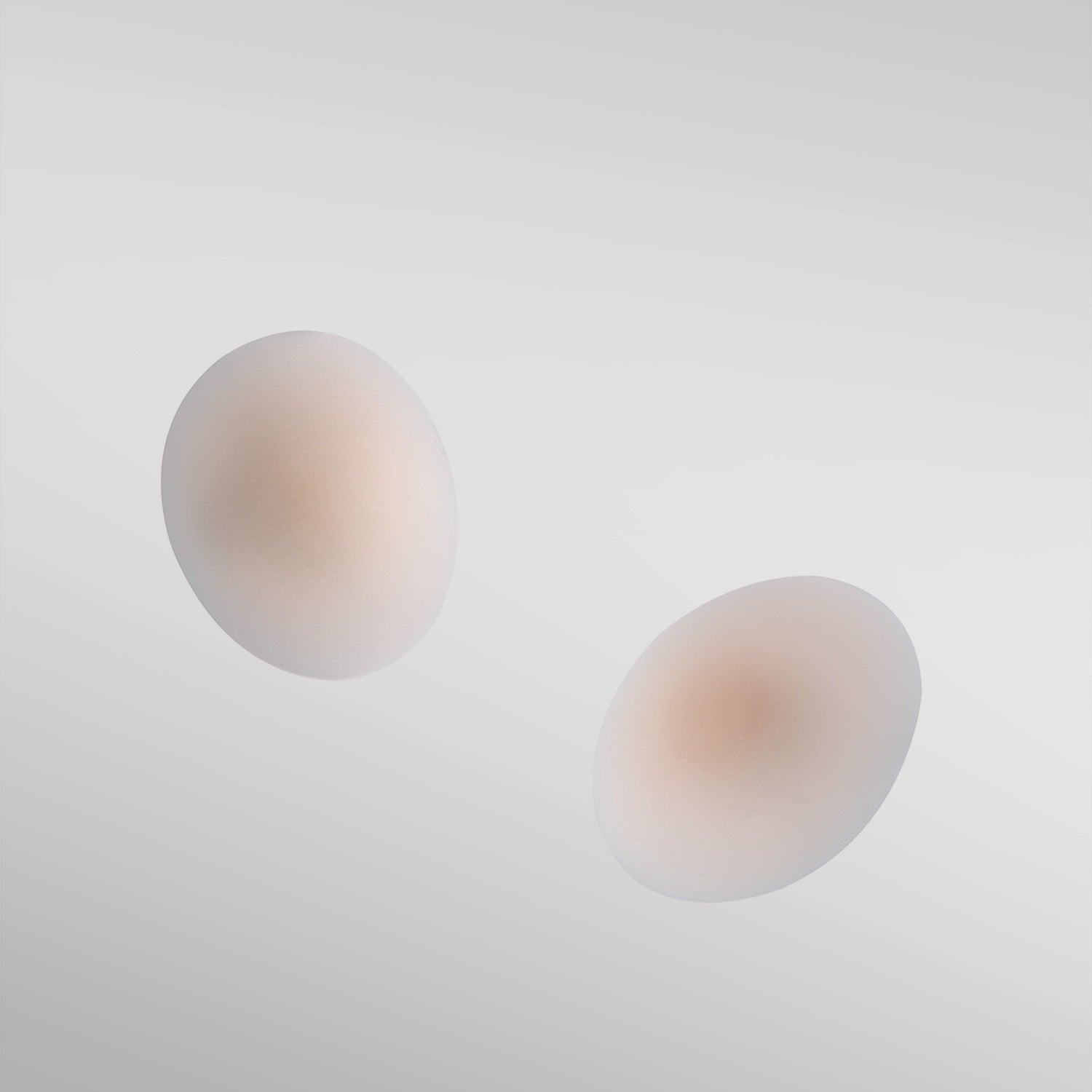 Two Naturelle silicone petals in fair shade on white background