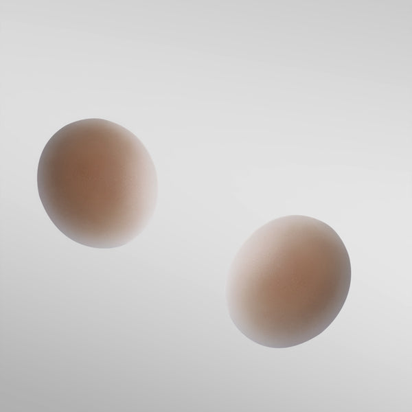 Two Naturelle silicone petals in tan shade on white background